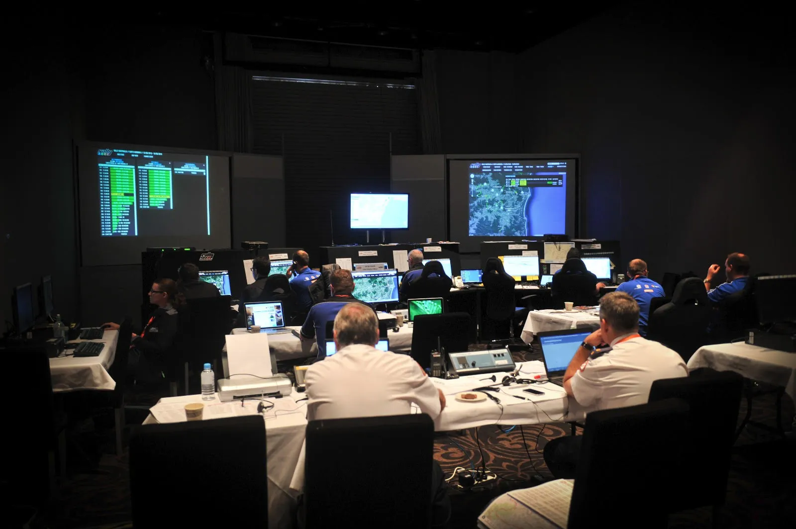 Officials working in a race control room